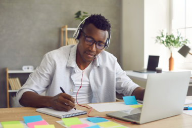 Man on laptop taking an online live proctored exam