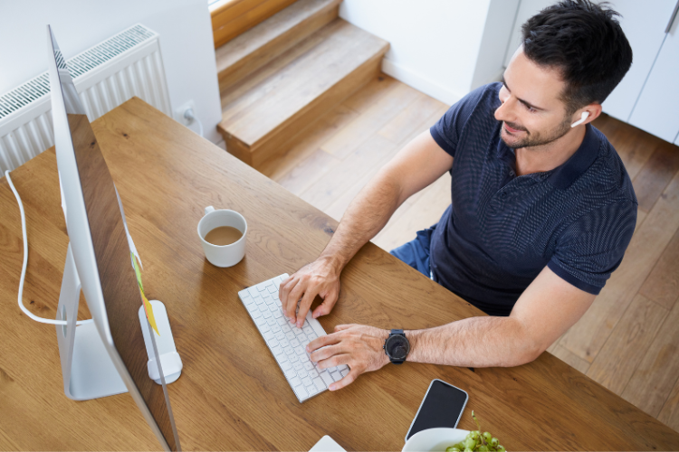 Man typing on desktop computer